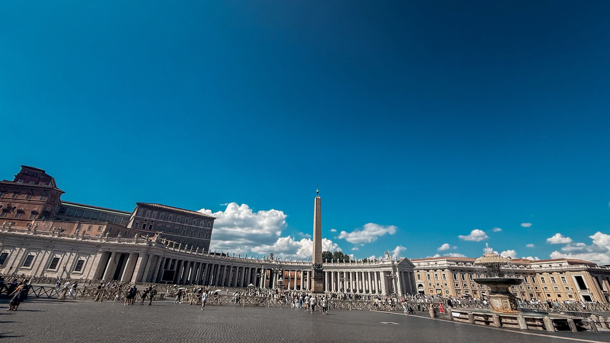 Panorama of St. Peter's Square under a deep blue sky
