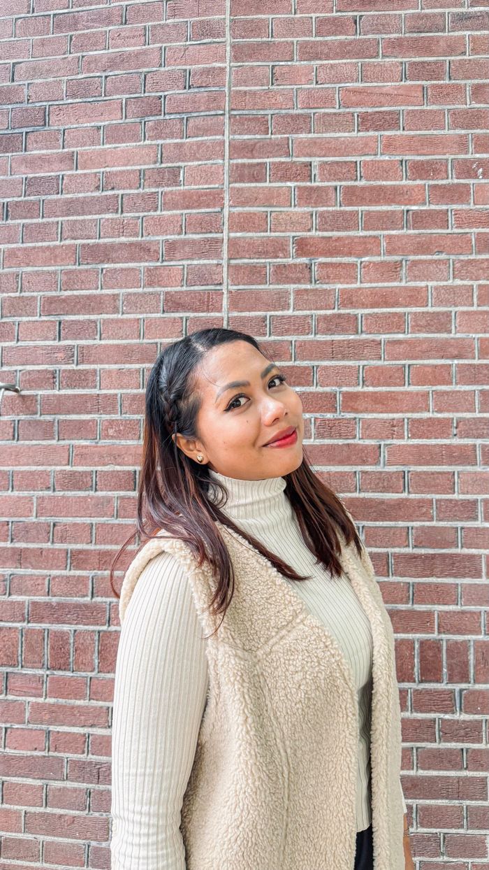 Portrait of Jojor Delima in front of a brick wall